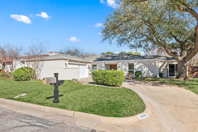 ranch-style house featuring driveway, a garage, a gate, and a front yard