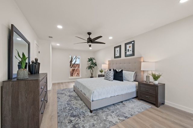 bedroom with recessed lighting, light wood-style flooring, and baseboards