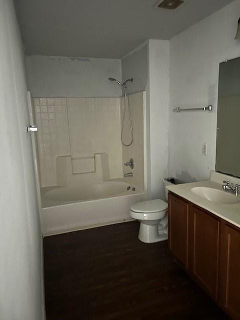 bathroom with bathtub / shower combination, vanity, toilet, and wood finished floors