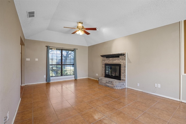 unfurnished living room with a fireplace, lofted ceiling, visible vents, ceiling fan, and tile patterned floors