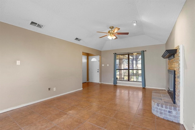 unfurnished living room with lofted ceiling, a fireplace, visible vents, and a ceiling fan