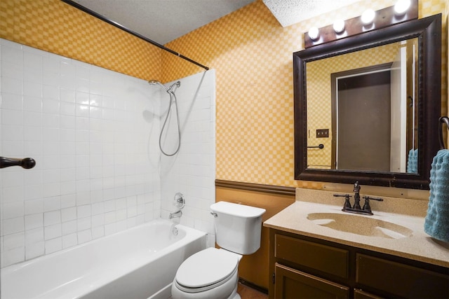 bathroom featuring a textured ceiling, vanity, toilet, and wallpapered walls