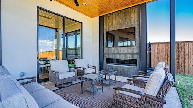 view of patio featuring outdoor lounge area and fence