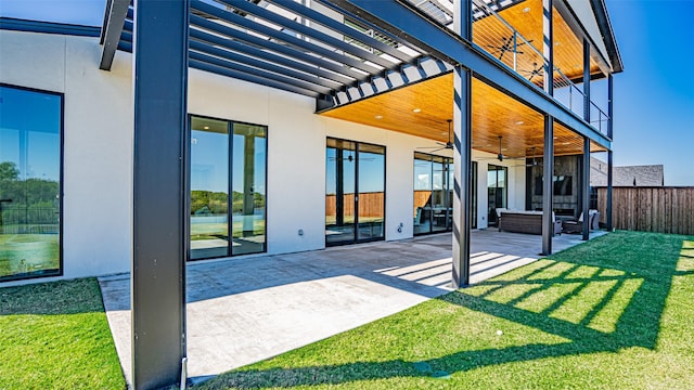 view of patio with a balcony, fence, and a ceiling fan