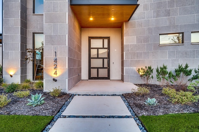 view of exterior entry with concrete block siding