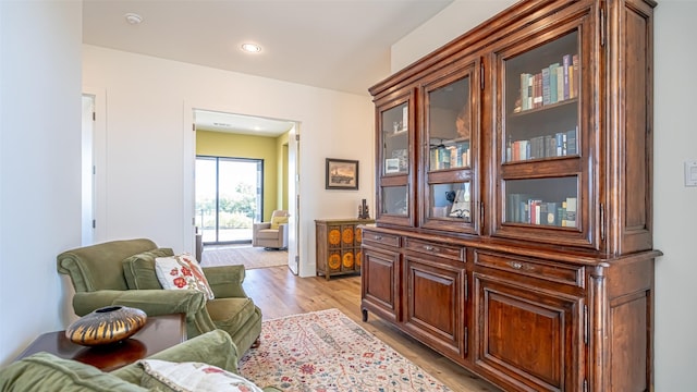 living area featuring recessed lighting and light wood finished floors