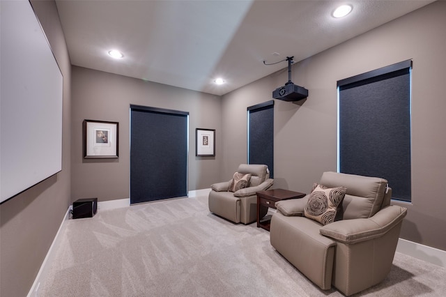 home theater featuring recessed lighting, light colored carpet, and baseboards