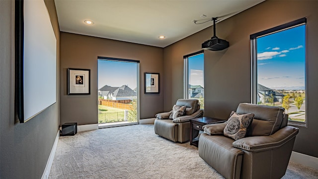 living area featuring carpet, baseboards, and recessed lighting