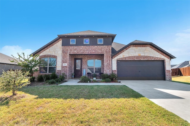 view of front of home featuring a garage, stone siding, brick siding, and concrete driveway