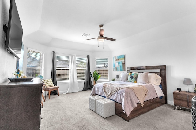 carpeted bedroom with baseboards, visible vents, and a ceiling fan