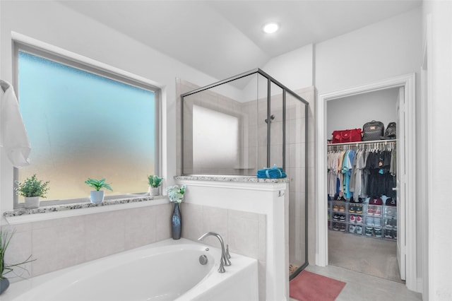 full bathroom featuring a stall shower, a spacious closet, recessed lighting, and a bath