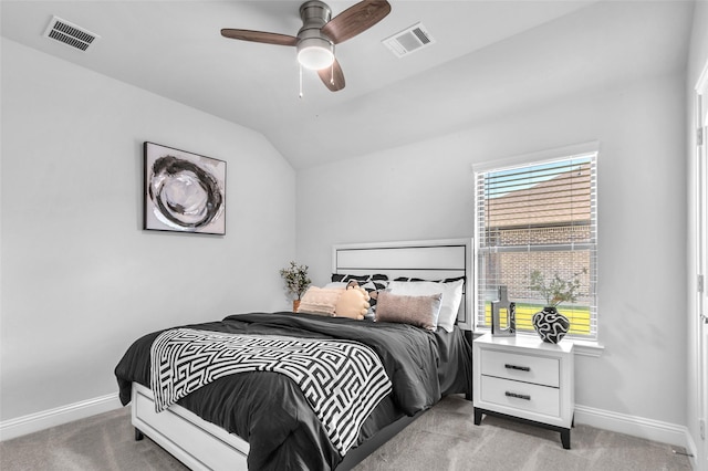 bedroom with lofted ceiling, visible vents, light carpet, and baseboards