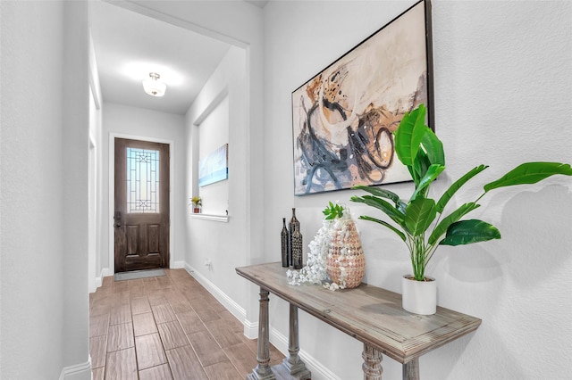 foyer with wood finish floors and baseboards