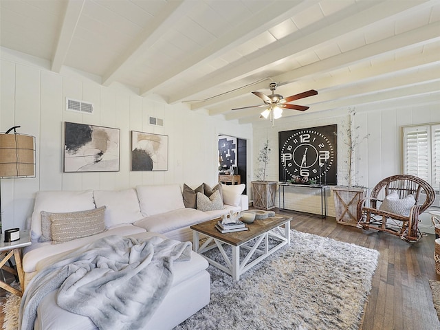 living area with ceiling fan, visible vents, dark wood finished floors, and beamed ceiling