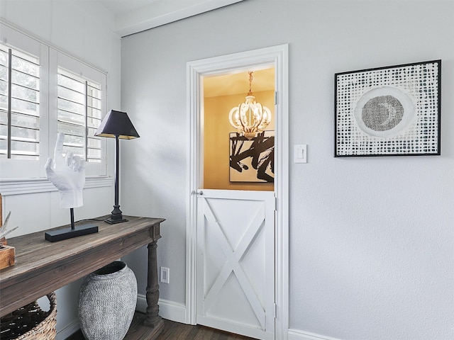 office with baseboards, dark wood-style flooring, and an inviting chandelier