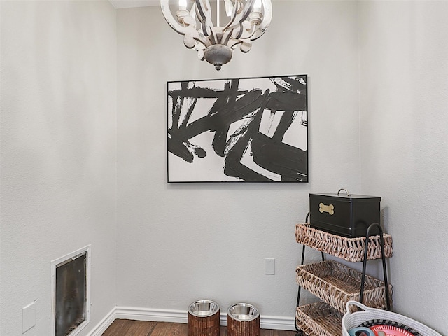 room details with an inviting chandelier and baseboards