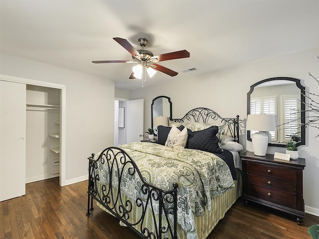 bedroom featuring baseboards, visible vents, a ceiling fan, wood finished floors, and a closet