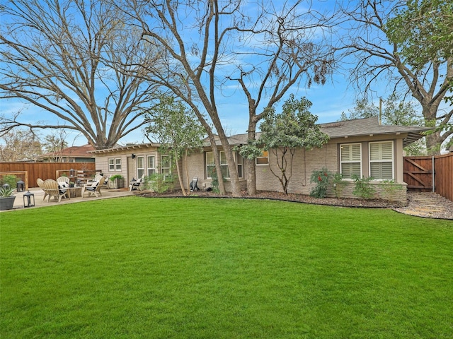 back of property featuring a yard, a patio area, and fence