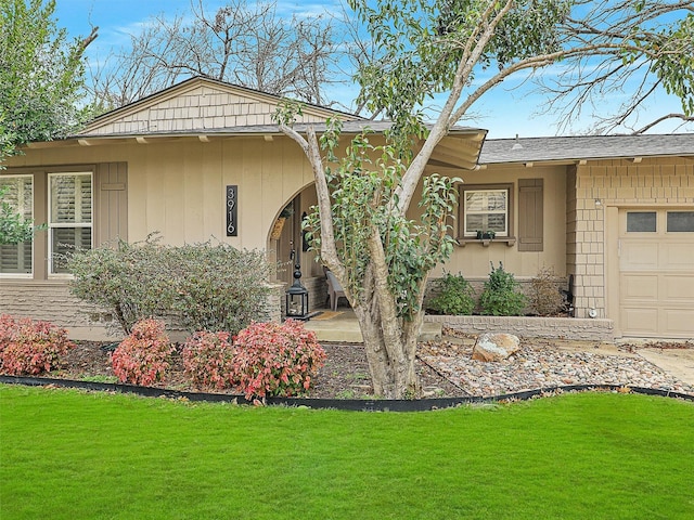 view of front facade with an attached garage and a front lawn