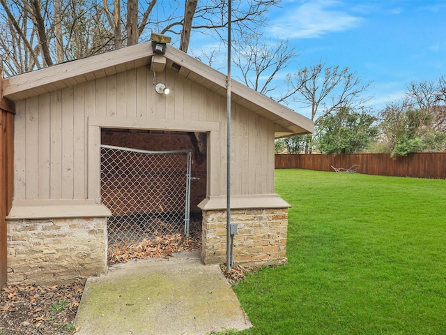 view of outdoor structure with an outbuilding and fence