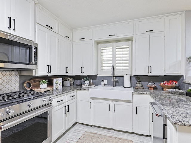 kitchen featuring white cabinetry, appliances with stainless steel finishes, and a sink