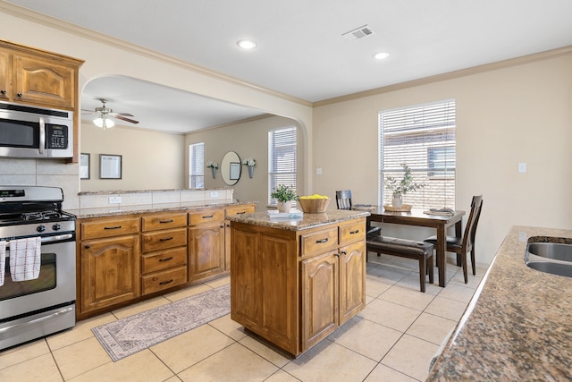 kitchen featuring light tile patterned floors, visible vents, appliances with stainless steel finishes, and backsplash