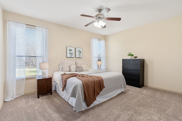 bedroom featuring light carpet and ceiling fan