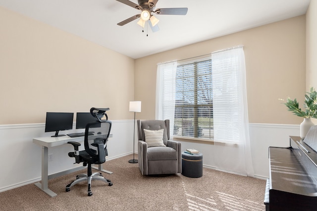 office space featuring carpet floors, ceiling fan, and baseboards