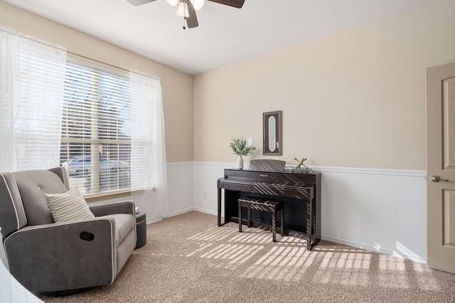 sitting room with carpet and ceiling fan