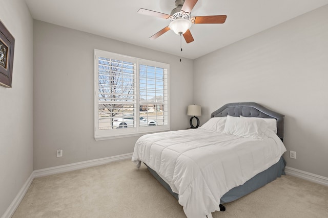 carpeted bedroom with a ceiling fan and baseboards