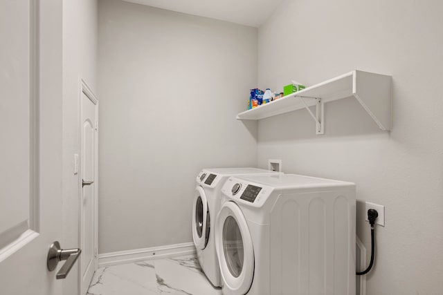 laundry room featuring washing machine and clothes dryer, laundry area, marble finish floor, and baseboards