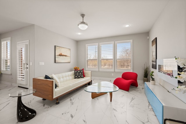 living room featuring recessed lighting, baseboards, and marble finish floor