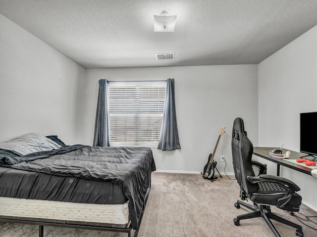 bedroom with carpet, a textured ceiling, visible vents, and baseboards