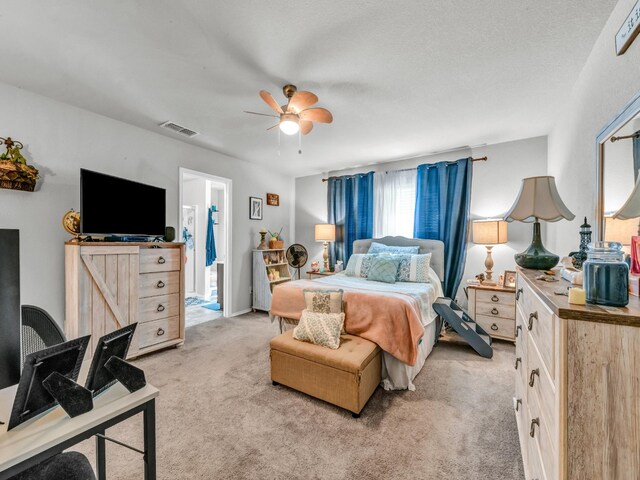 bedroom with ceiling fan, visible vents, and light colored carpet