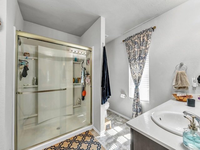 bathroom featuring a stall shower, vanity, and toilet