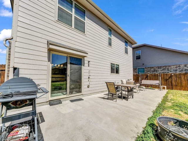 back of property with a patio area and fence