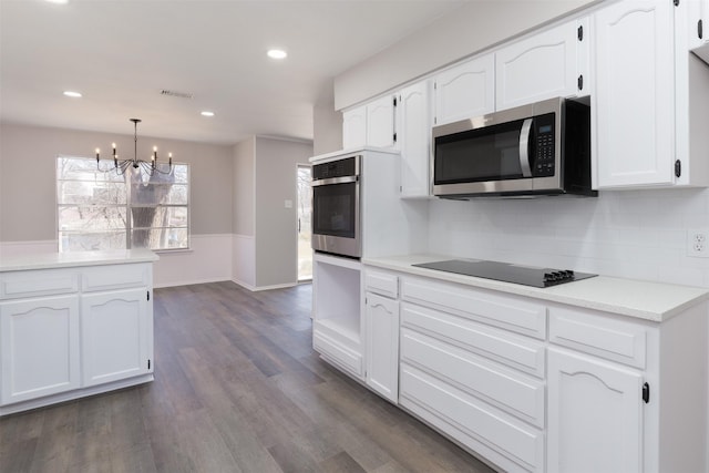 kitchen featuring white cabinetry, dark wood-style flooring, visible vents, and appliances with stainless steel finishes