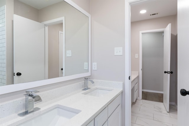 full bathroom with double vanity, visible vents, marble finish floor, and a sink