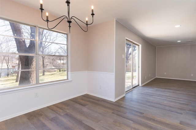 unfurnished dining area featuring a chandelier, recessed lighting, dark wood-type flooring, and baseboards