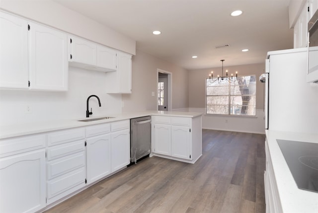 kitchen featuring a sink, white cabinetry, a peninsula, black electric stovetop, and dishwasher