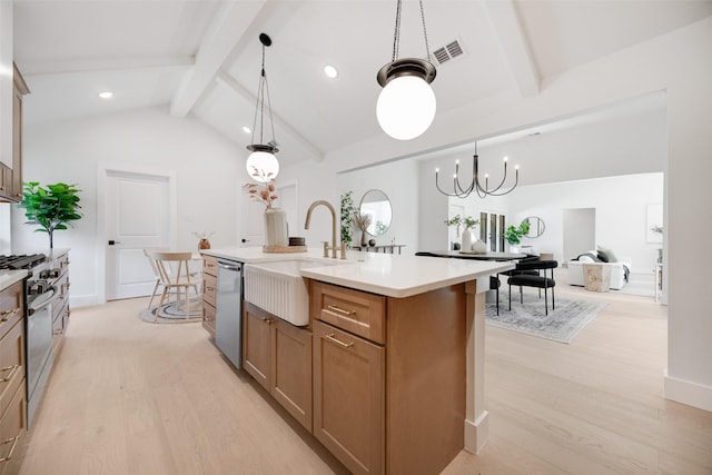 kitchen featuring a sink, light countertops, appliances with stainless steel finishes, beam ceiling, and light wood finished floors