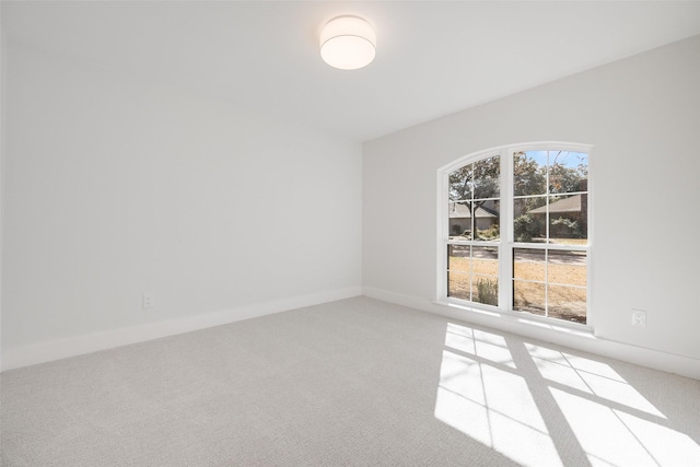 empty room featuring carpet flooring and baseboards