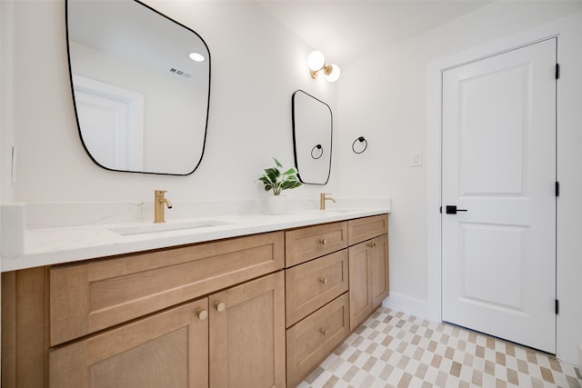 bathroom featuring double vanity, a sink, and visible vents