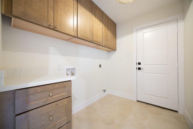 clothes washing area with cabinet space, hookup for a washing machine, baseboards, and hookup for an electric dryer