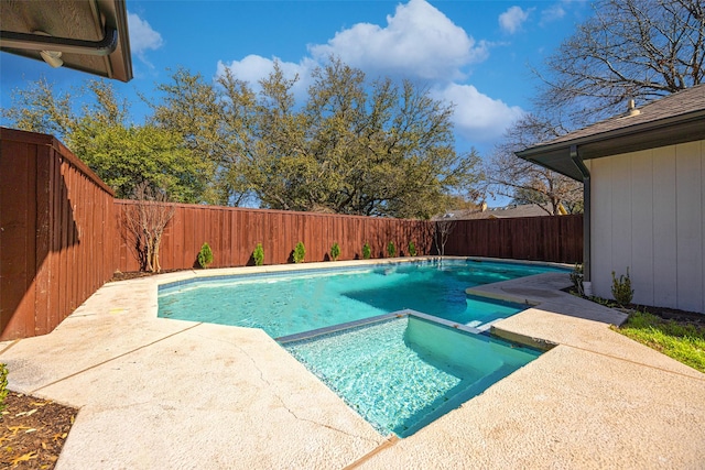 view of swimming pool with a patio, a fenced backyard, and a pool with connected hot tub