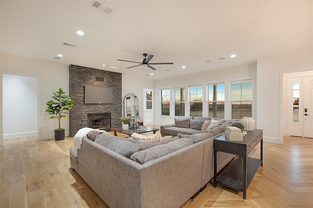 living area with ceiling fan, baseboards, and visible vents