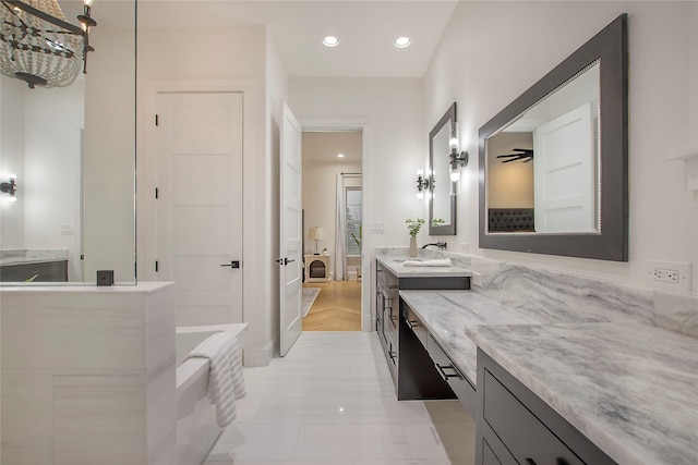 full bath featuring vanity, recessed lighting, and a bathing tub