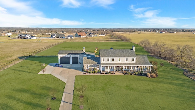 view of front of property featuring stone siding, driveway, a chimney, and a lawn