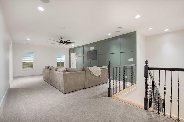 living area with light carpet, baseboards, a ceiling fan, and recessed lighting