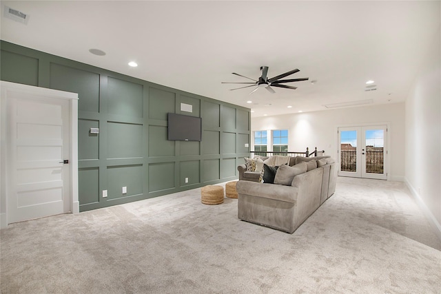 carpeted spare room featuring ceiling fan and baseboards